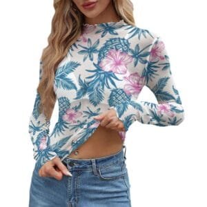 Woman modeling a sheer, long-sleeve women's upside down pineapple top with a subtle blue and pink tropical floral pattern.
